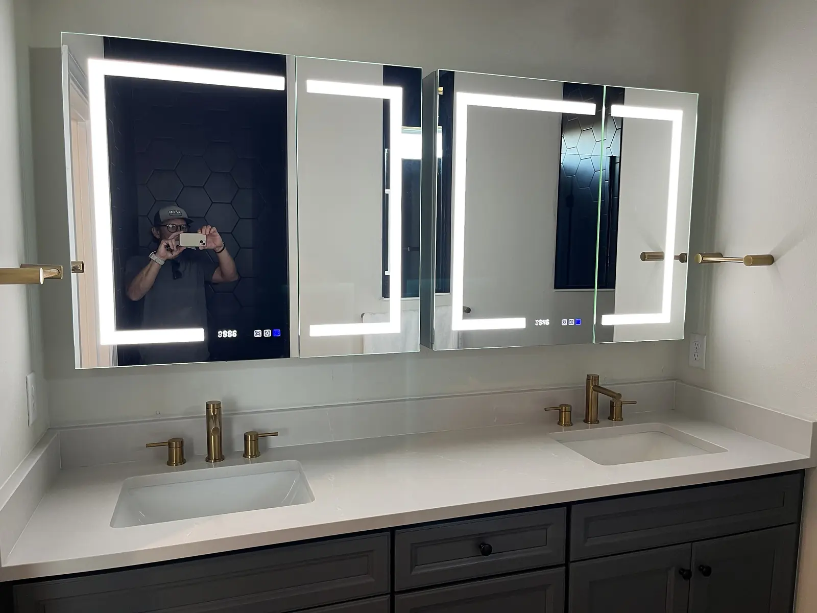 Two illuminated LED mirrors above a double bathroom vanity