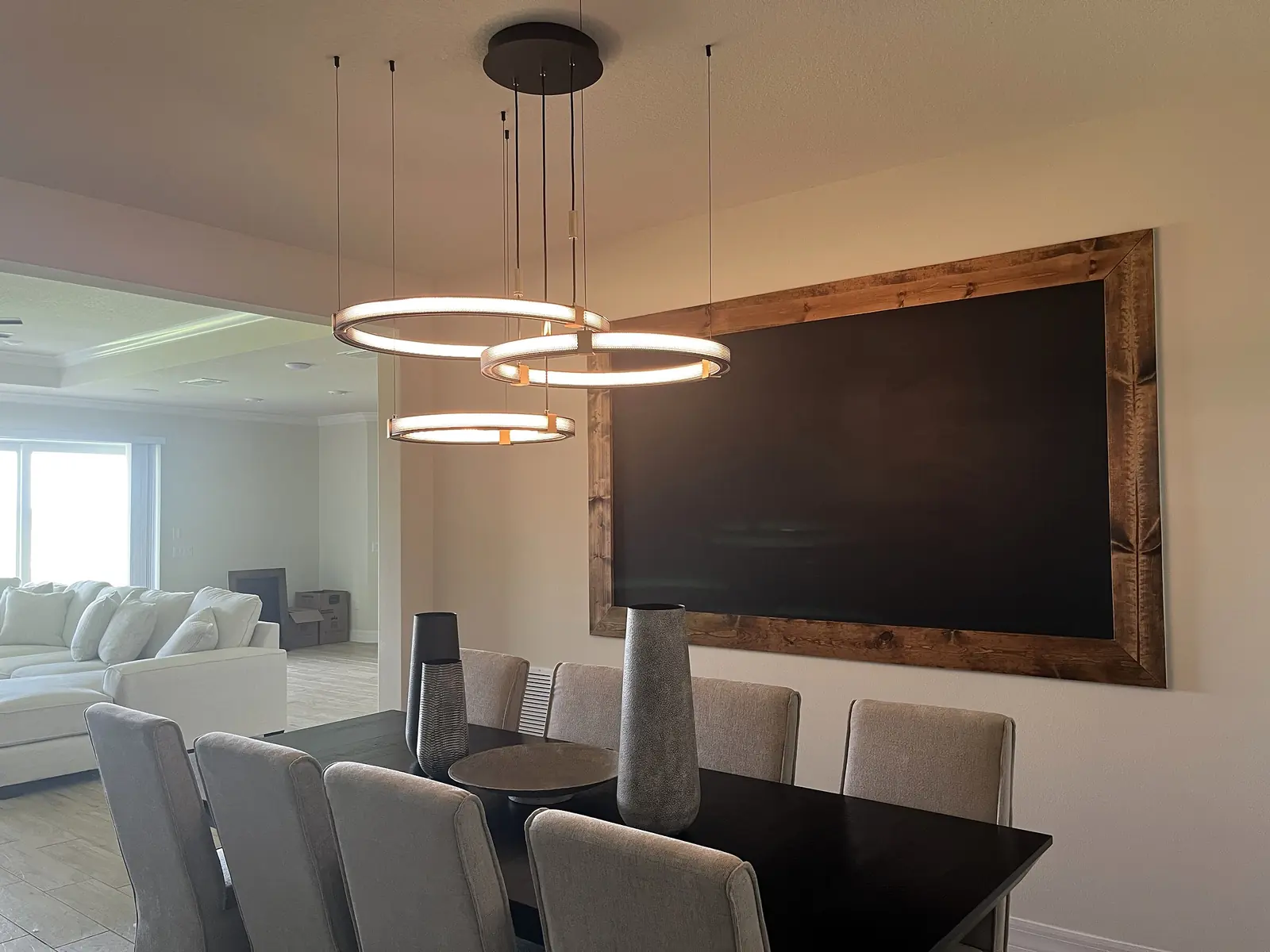 Illuminated modern ring pendant in an open dining room