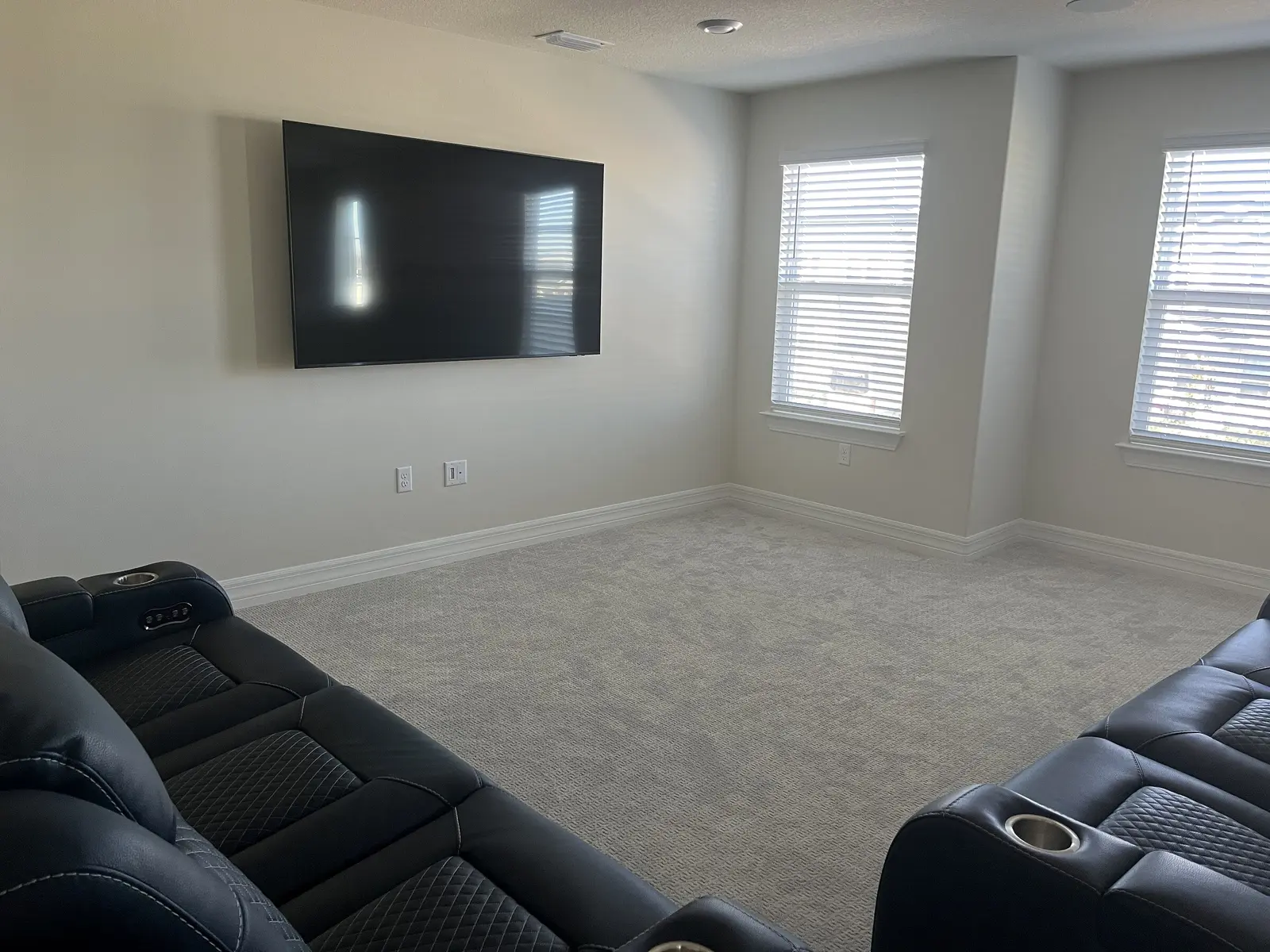 Wall-mounted television facing a family-room seating area