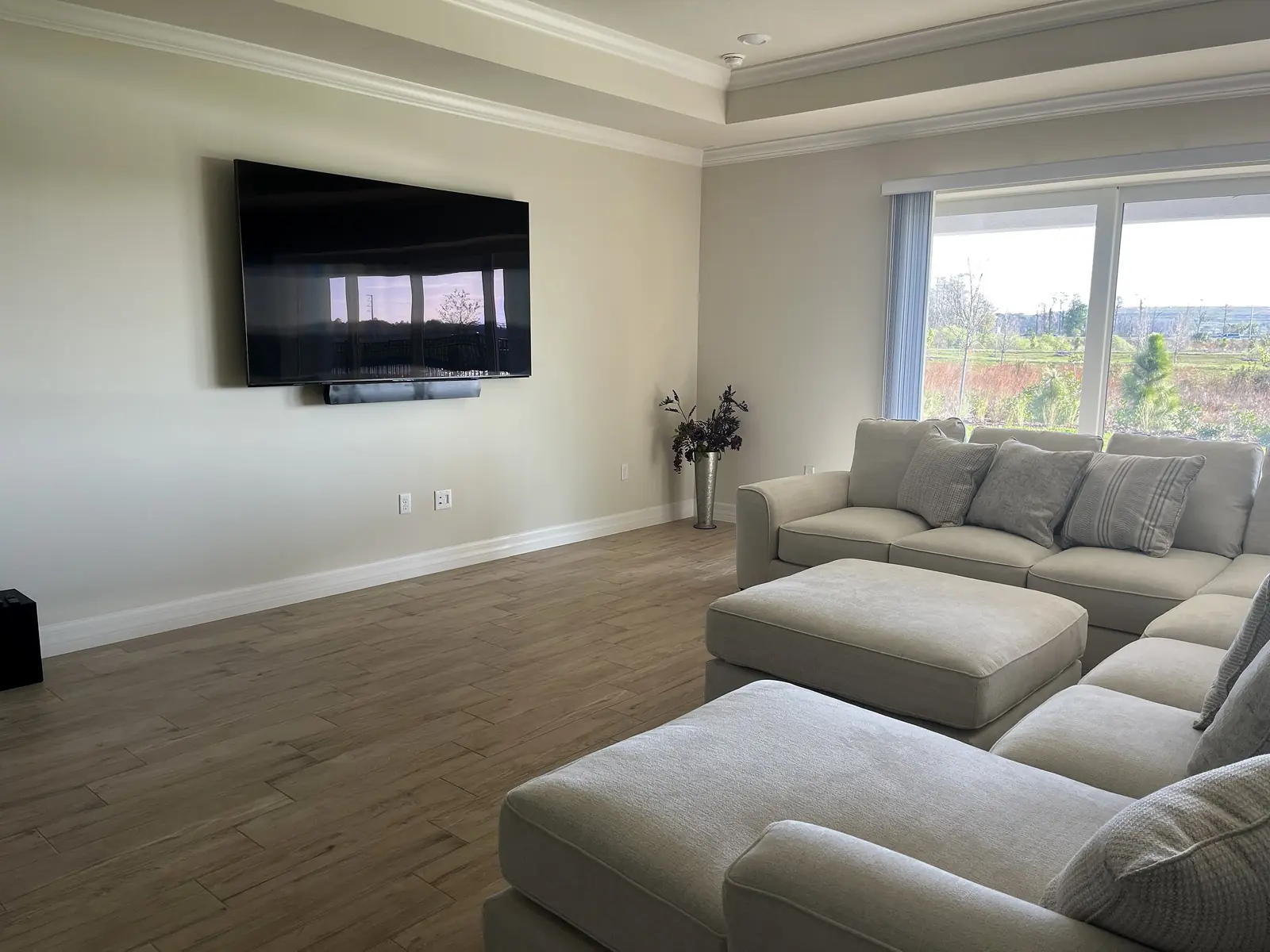 Centered wall-mounted television in an open living room