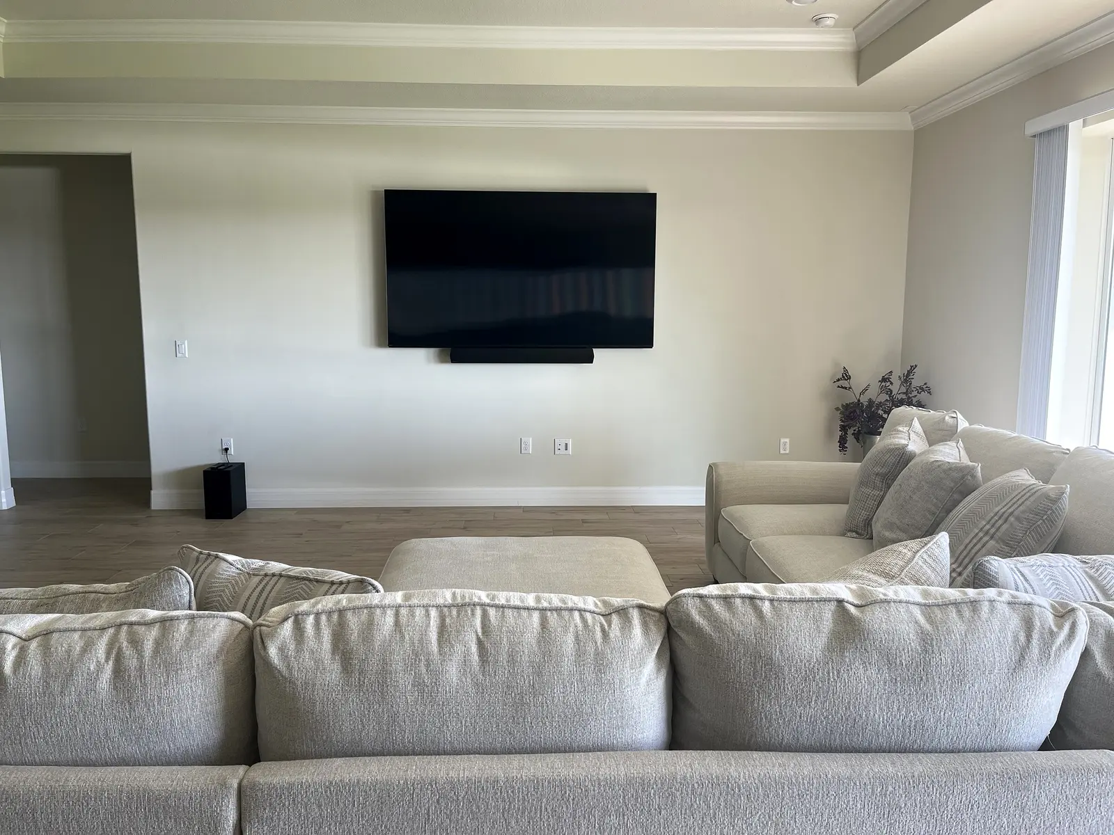 Large wall-mounted television aligned with living-room seating
