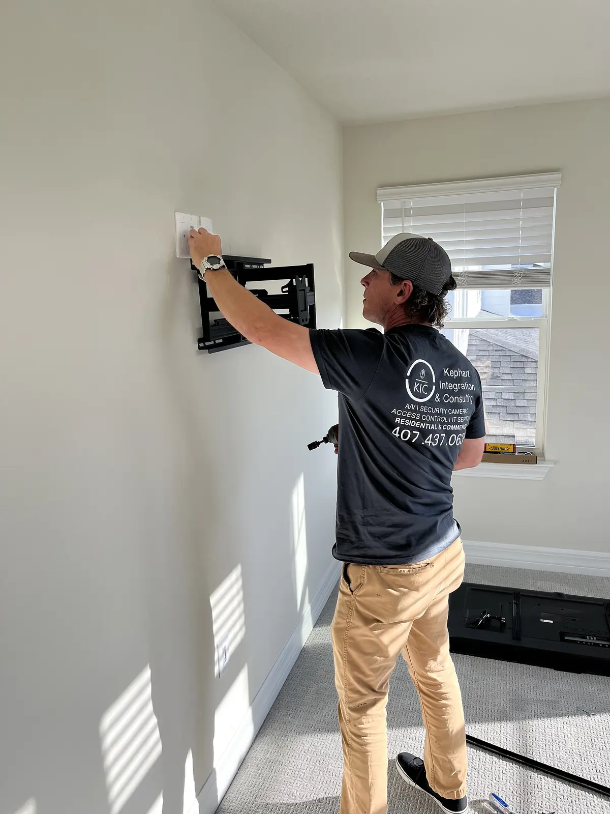 Orange Structural technician preparing a television wall bracket