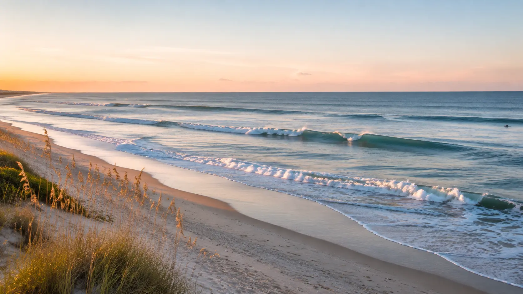 Small clean Atlantic waves and a distant surfer on Florida’s Space Coast