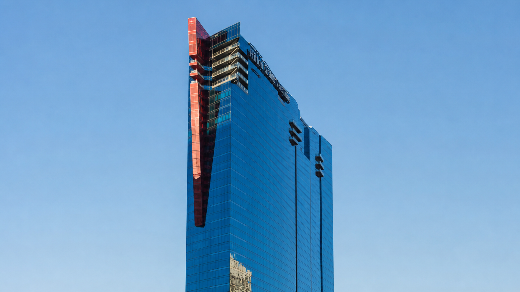 Upper Hilton Grand Vacations tower framed by clear Las Vegas sky